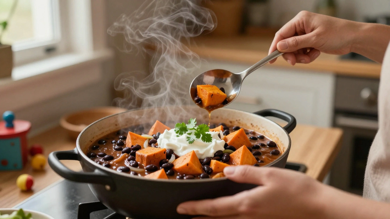 A bowl of black bean and sweet potato chili topped with yogurt and cilantro, served in a cozy home kitchen.